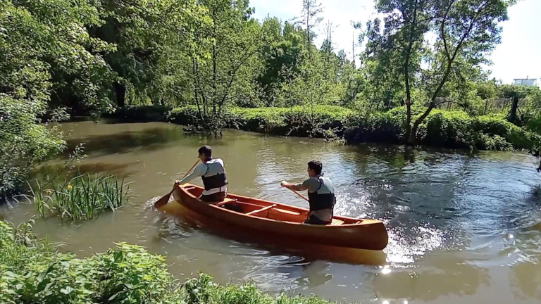 Image 6 - Tandem canoe paddler paddling on a river