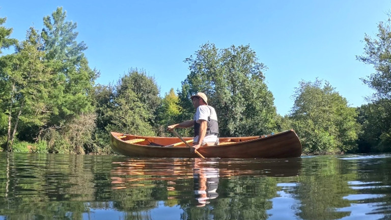 Image 4 - Solo canoe paddler on a river