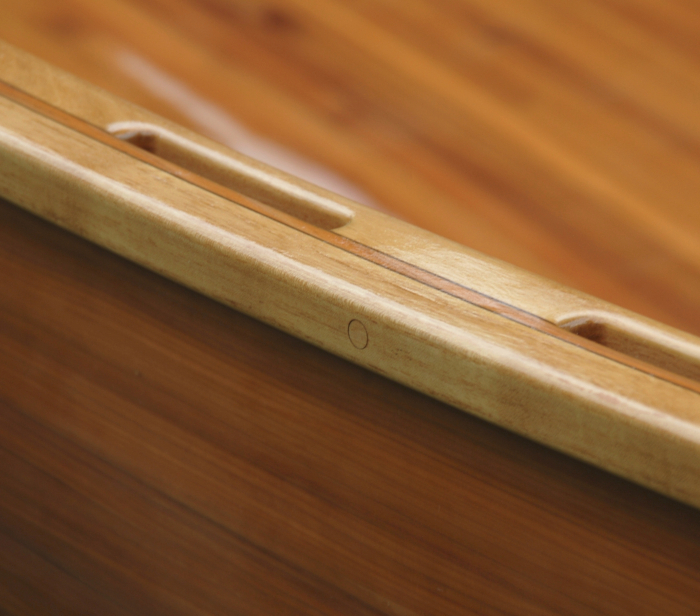 Image 6 - wooden open touring canoe, detailed view on a gunwale and scuppers